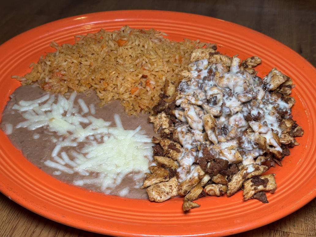 Pollo Feliz - grilled chicken with rice and beans on orange plate