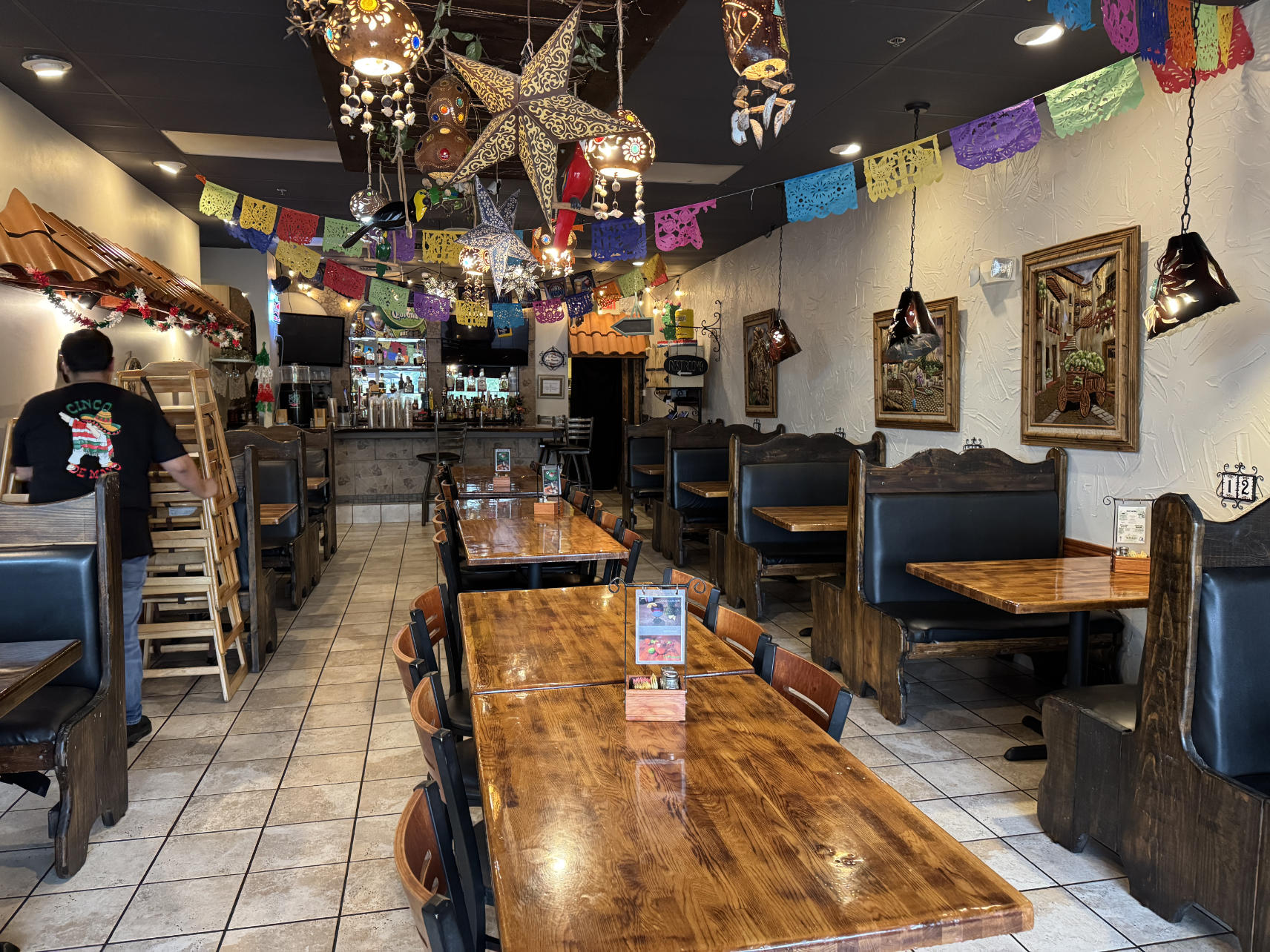 El Monte interior with papel picado, star lanterns, and rustic decor