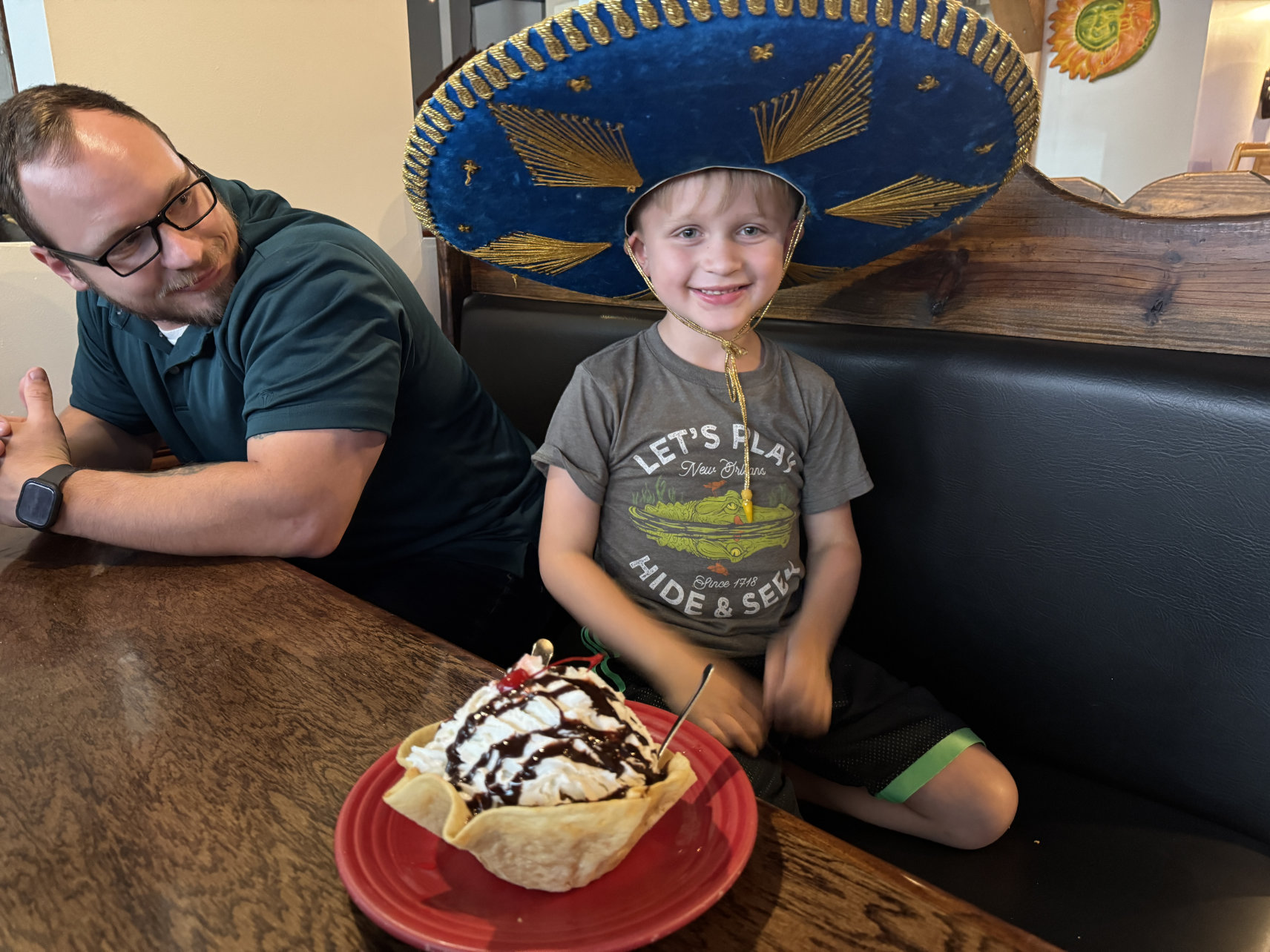 Kid wearing sombrero with dessert at El Monte